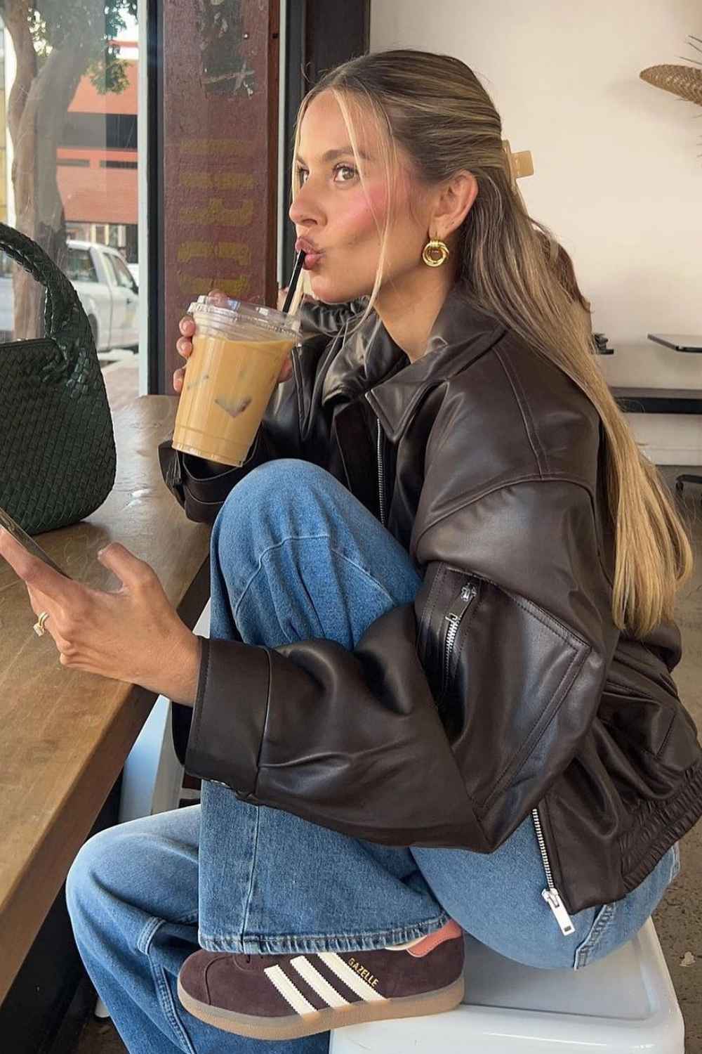 brown leather jacket with jeans and suede sneakers