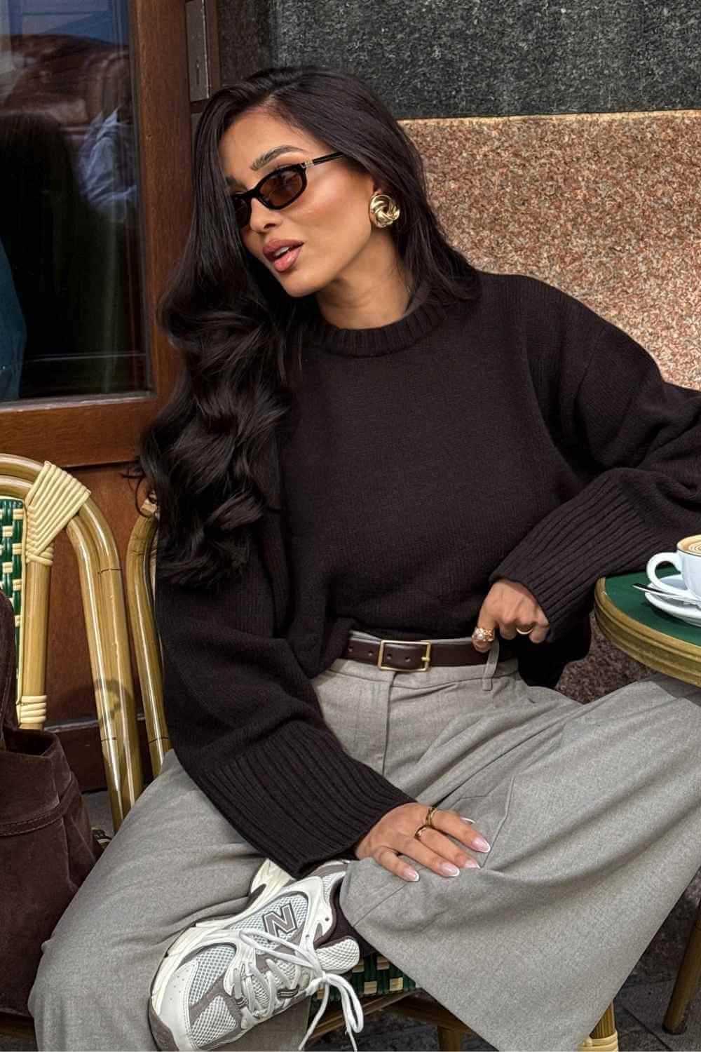 brown sweater with gray trousers and sneakers