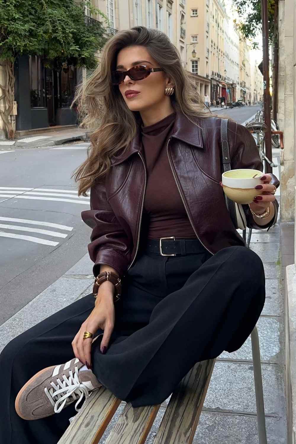 burgundy leather jacket with brown turtleneck and black trousers