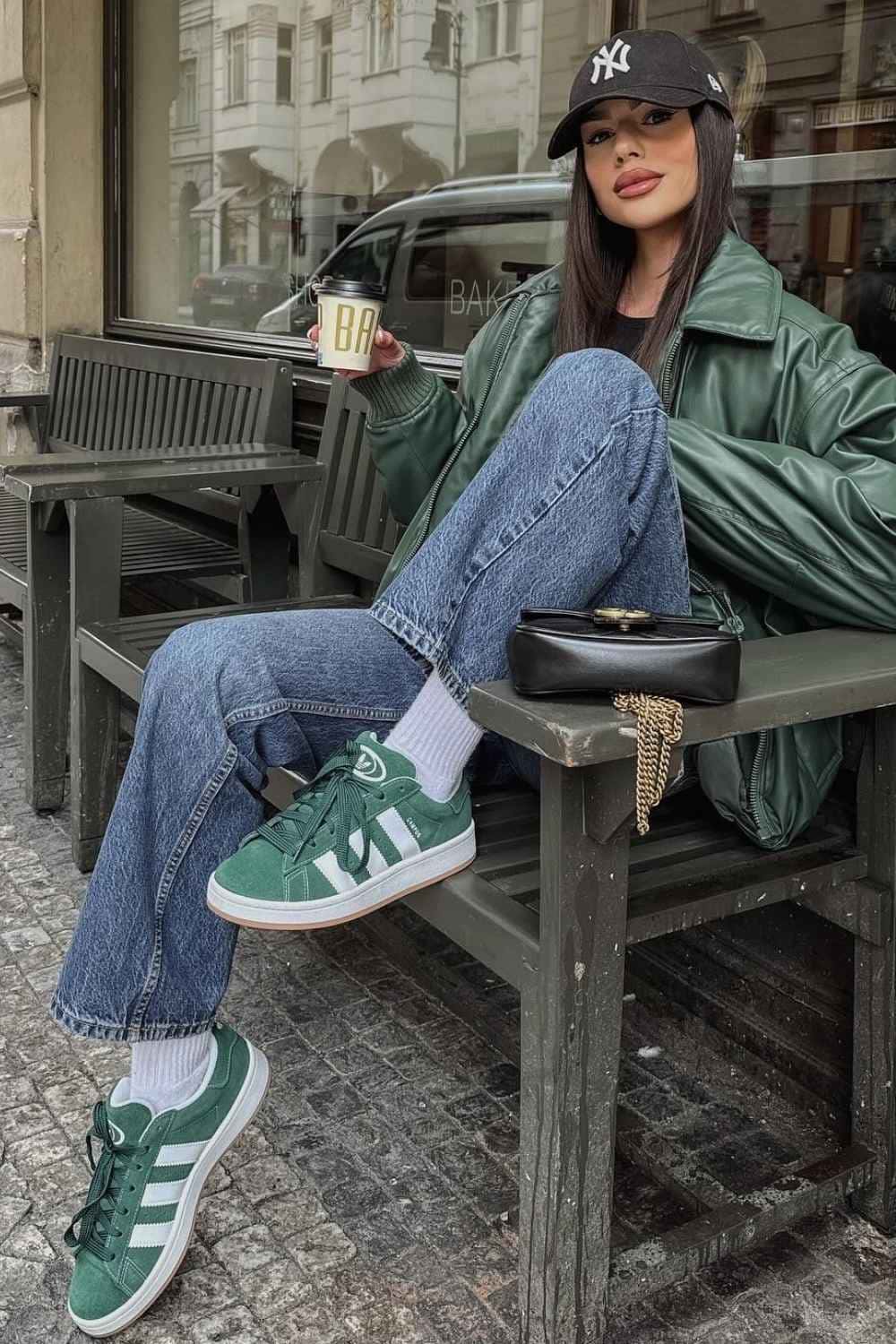 green leather jacket with jeans and matching green sneakers