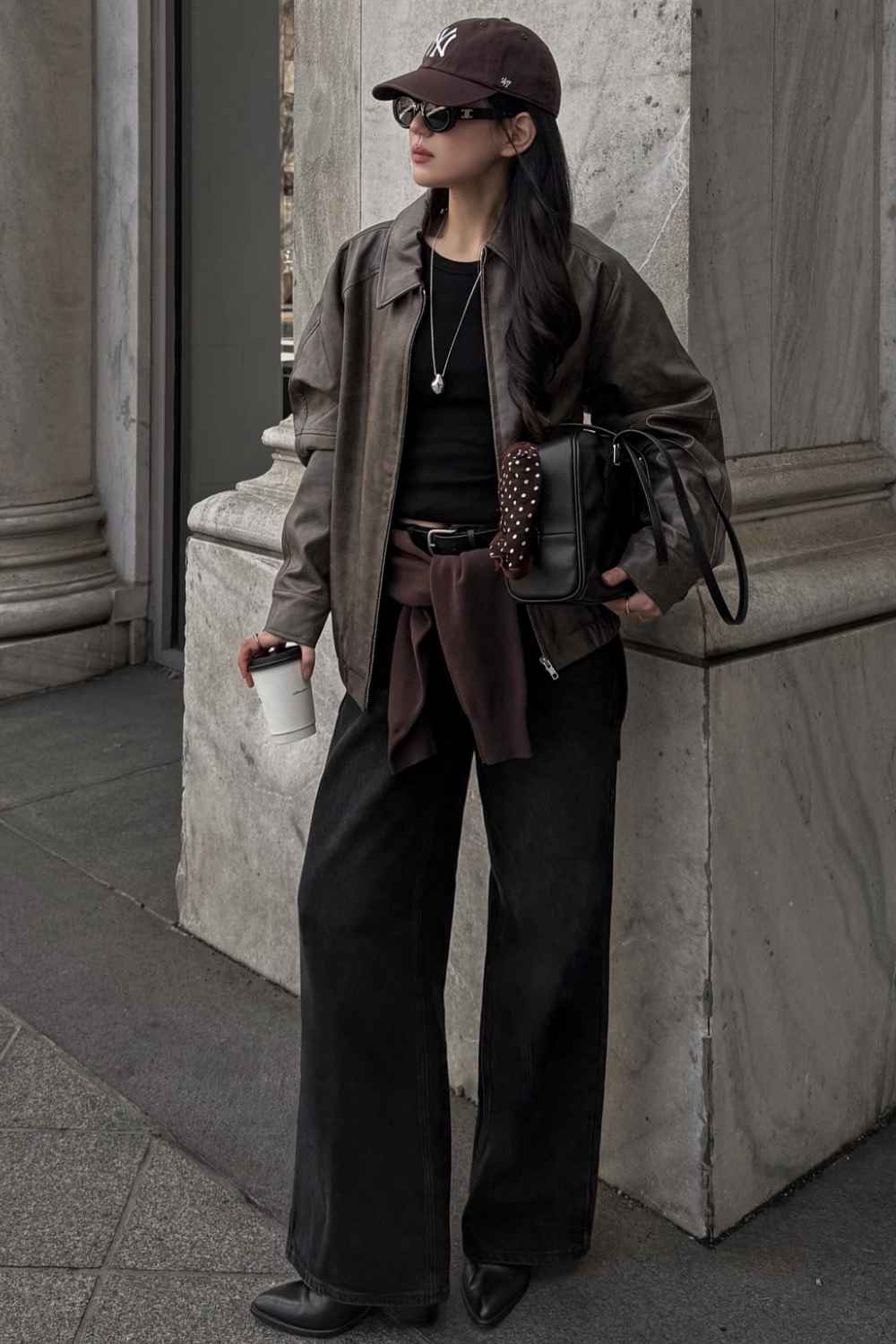 leather jacket with baseball cap and black jeans