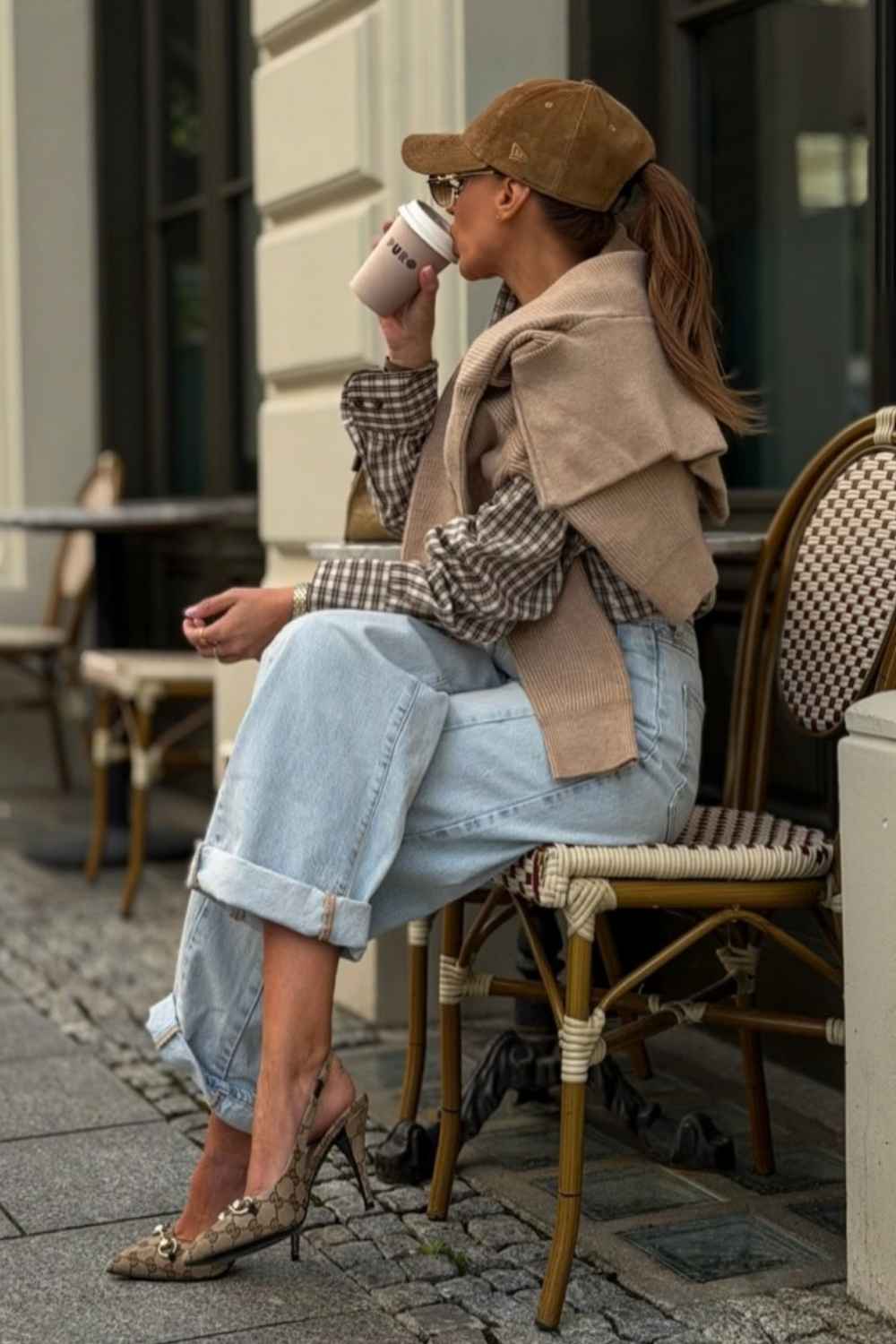 sweater draped over gingham shirt with baggy jeans