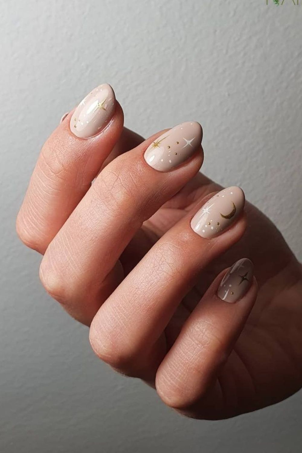 Beige nails with celestial accents