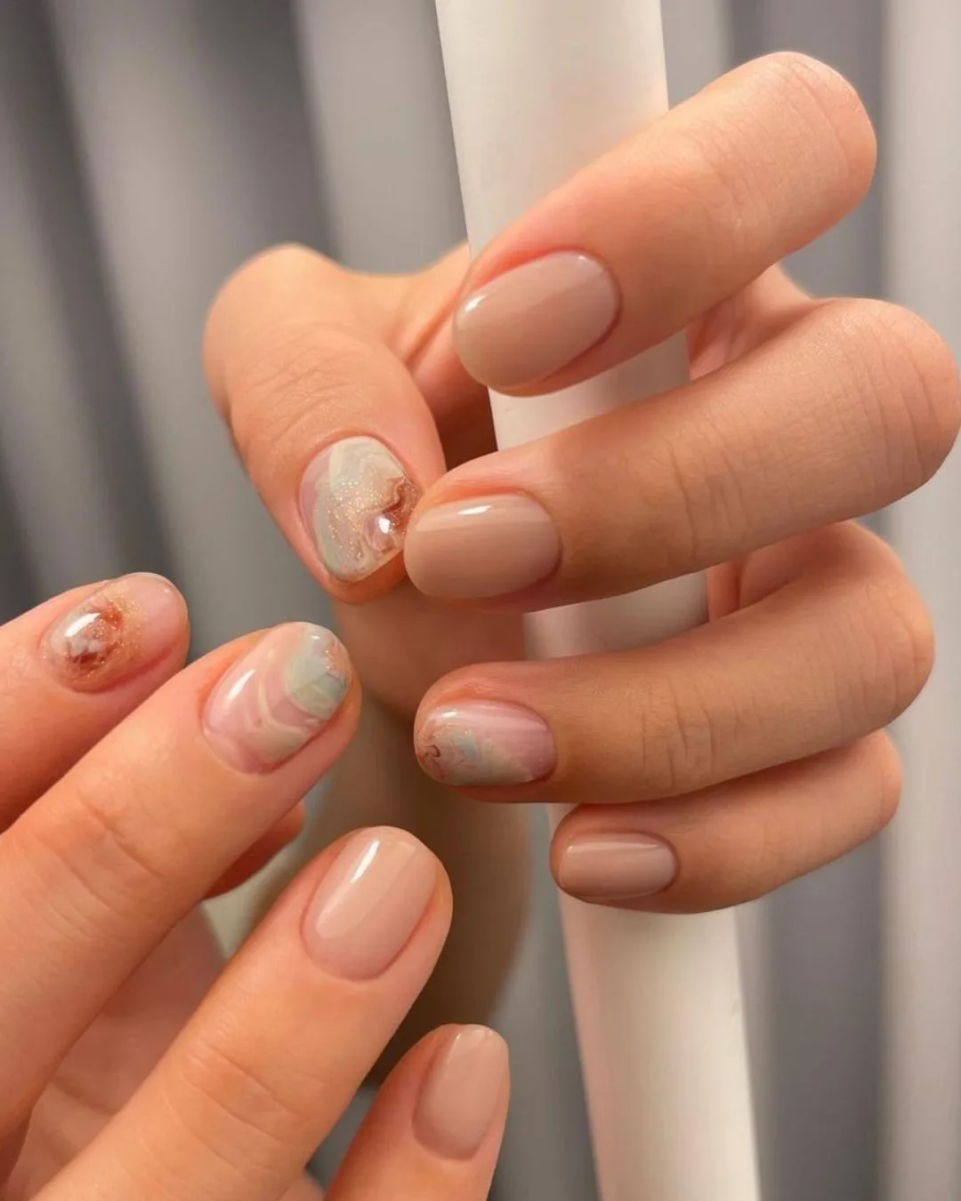 Beige nails with marble accents