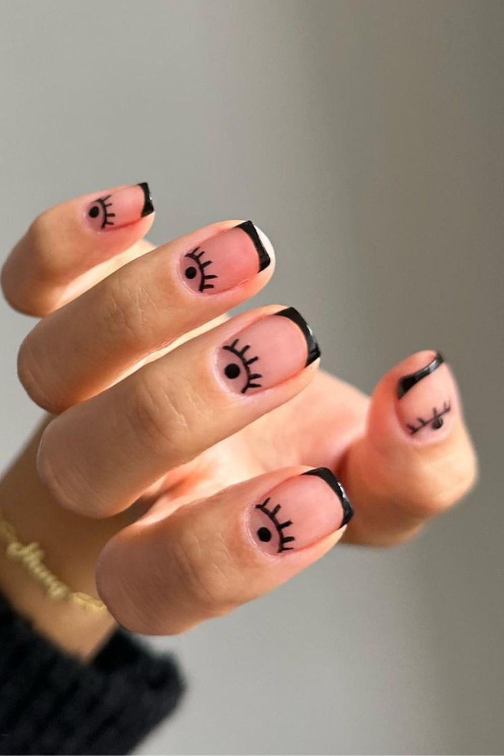 Black French nails with evil eye design