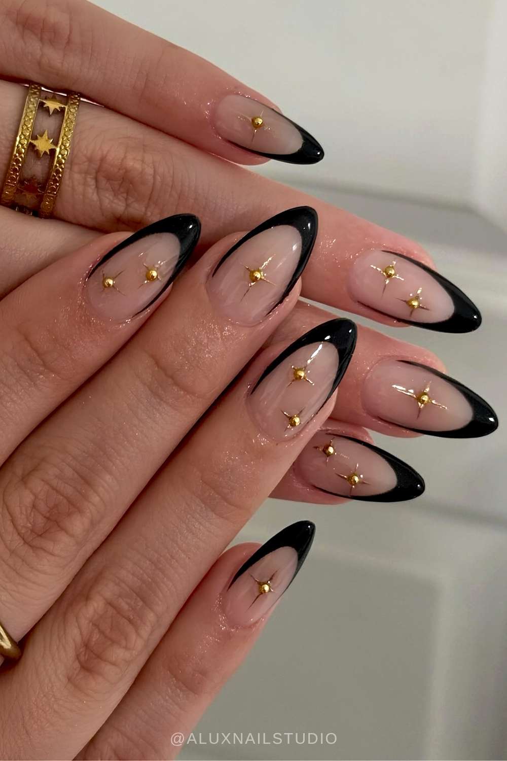 Black French nails with gold celestial details