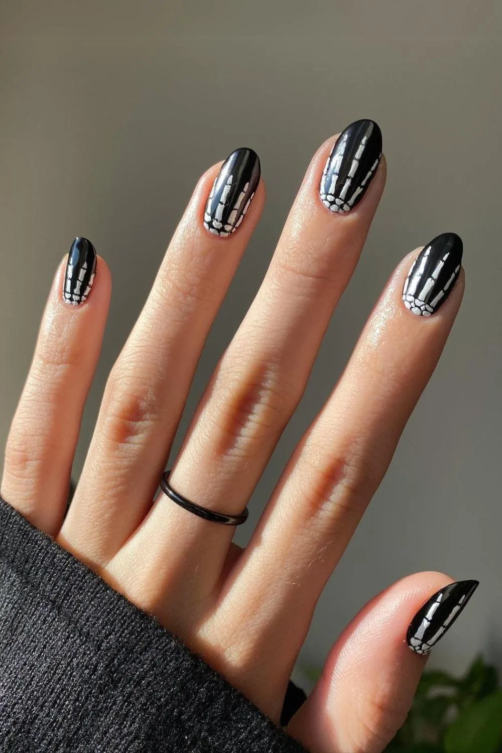 Black Halloween nails with skeleton hands design