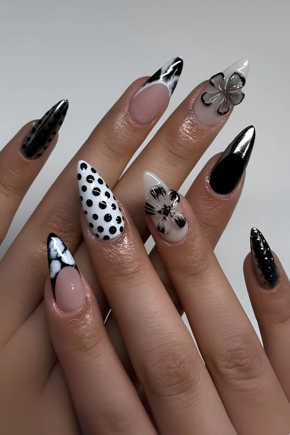 Black and white nails with polka dots and 3D flowers