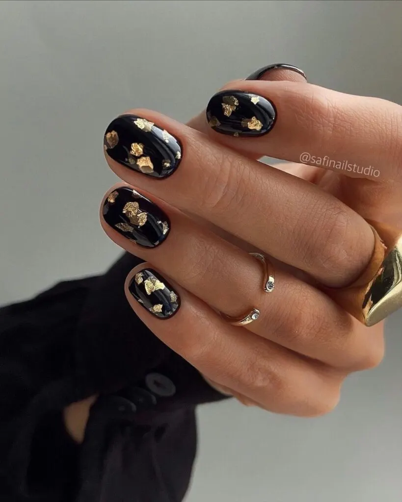 Black mani with gold foil flecks