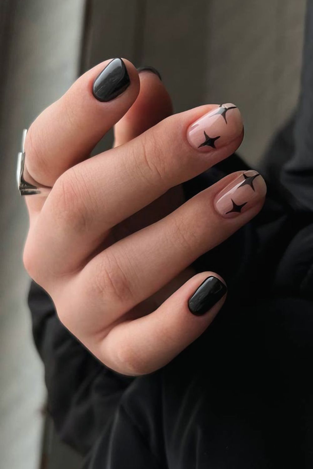 Black manicure with celestial accents