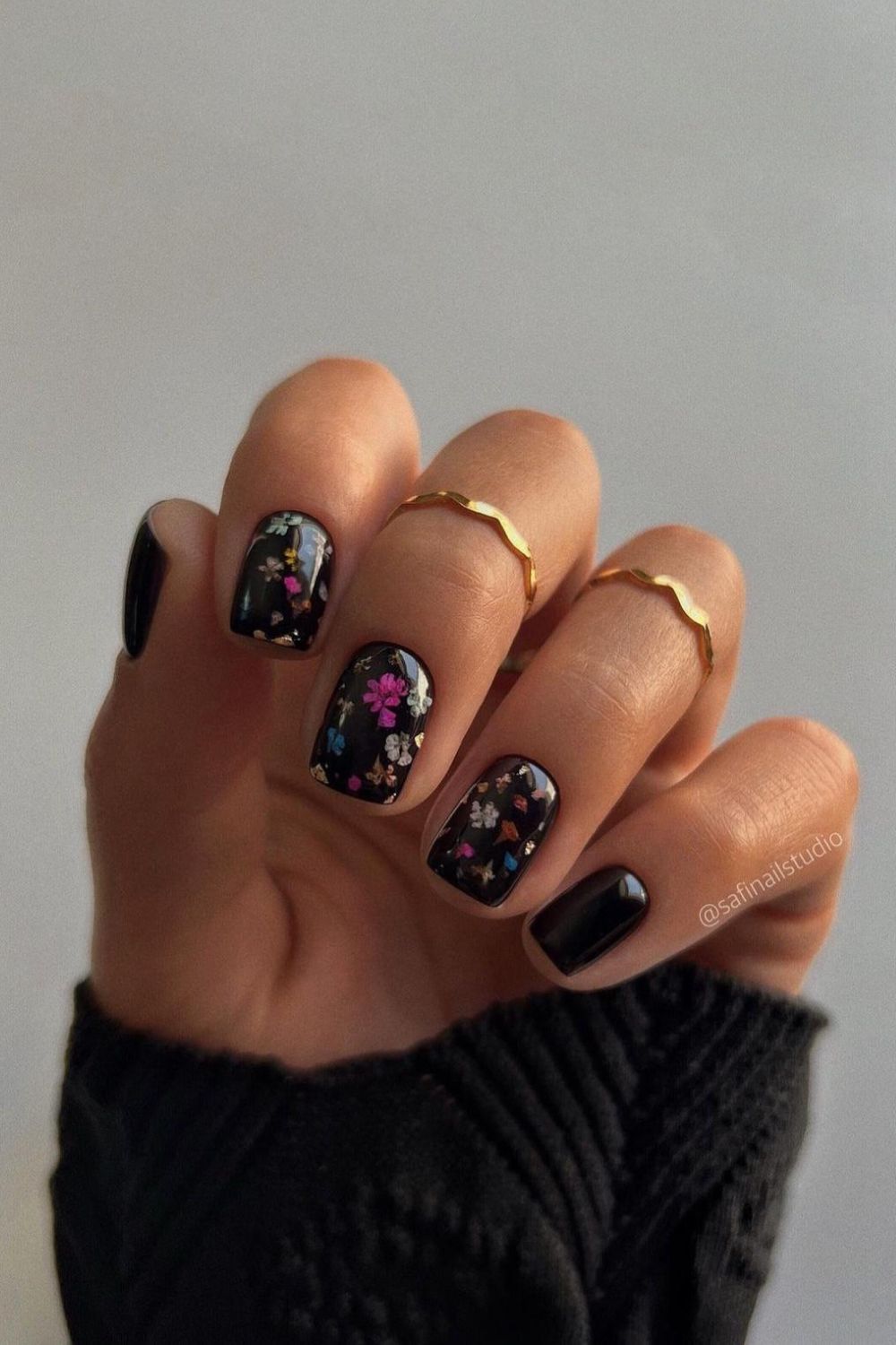 Black manicure with floral designs