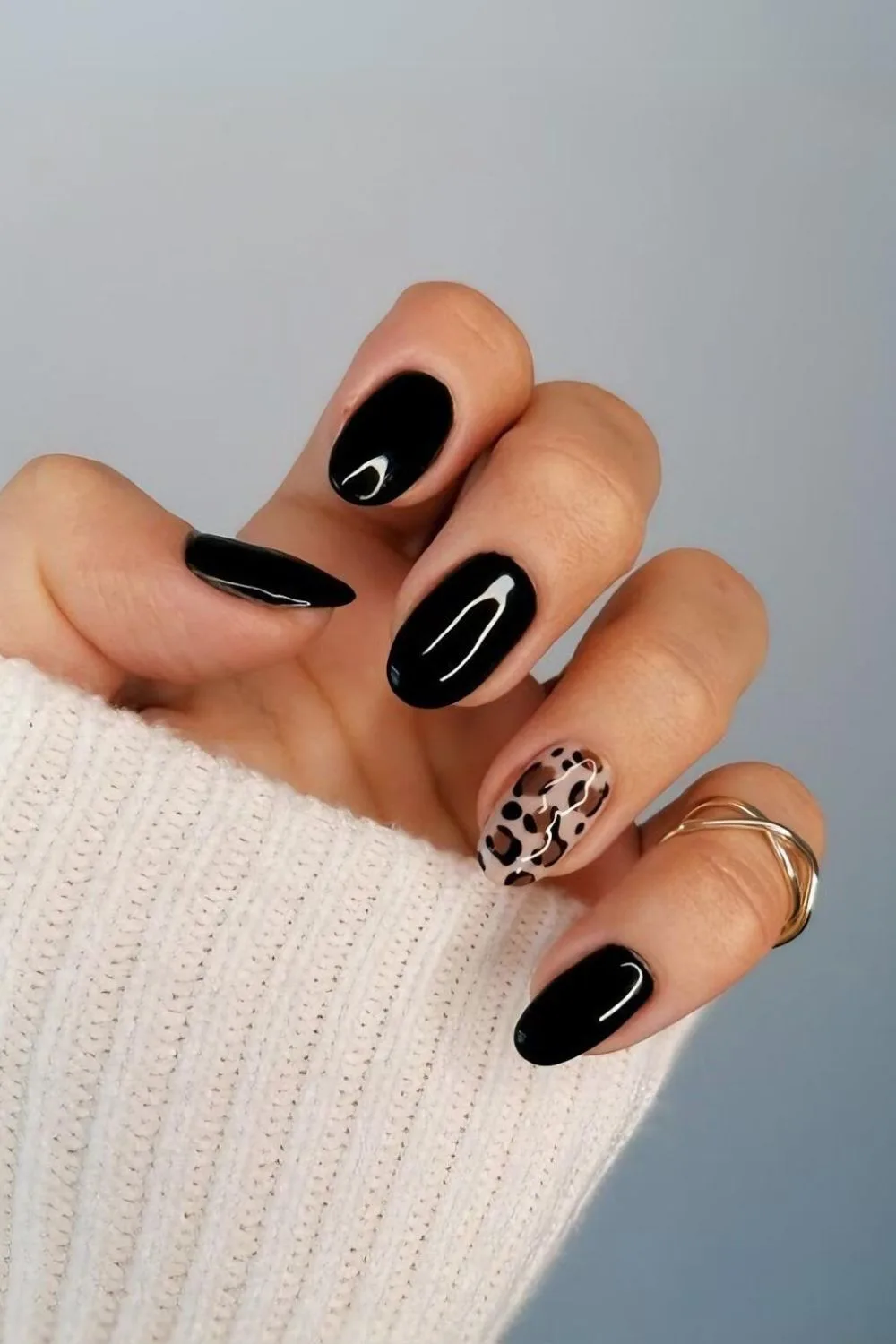 Black manicure with leopard print design