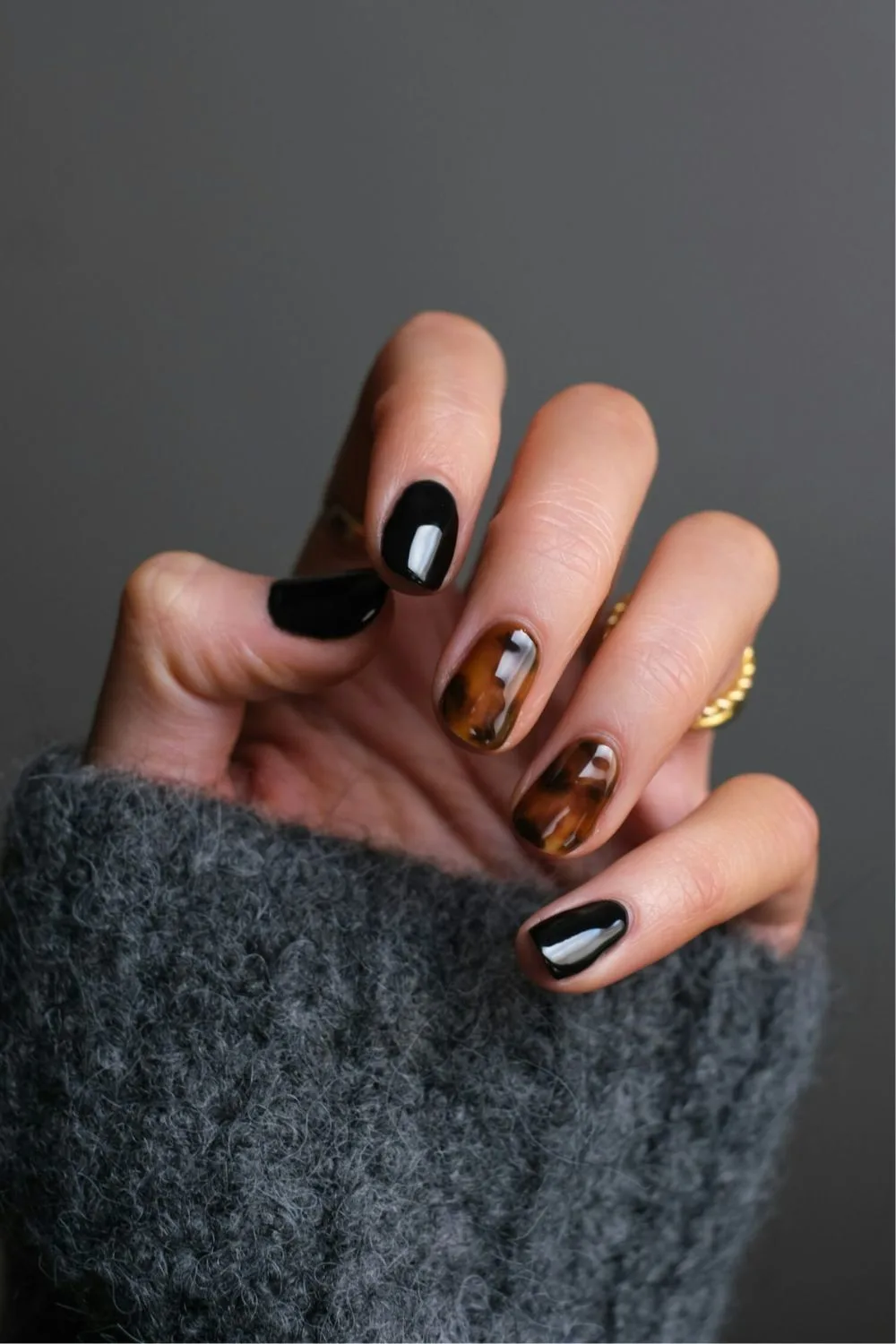 Black manicure with tortoise shell accents