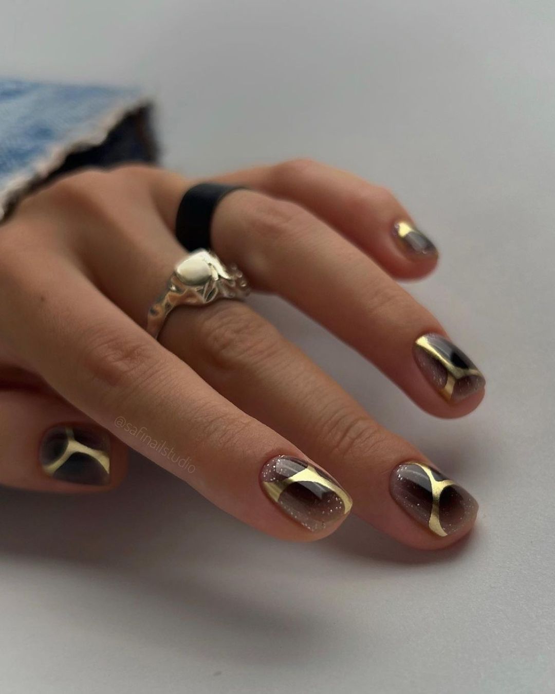 Black nails with abstract gold accent