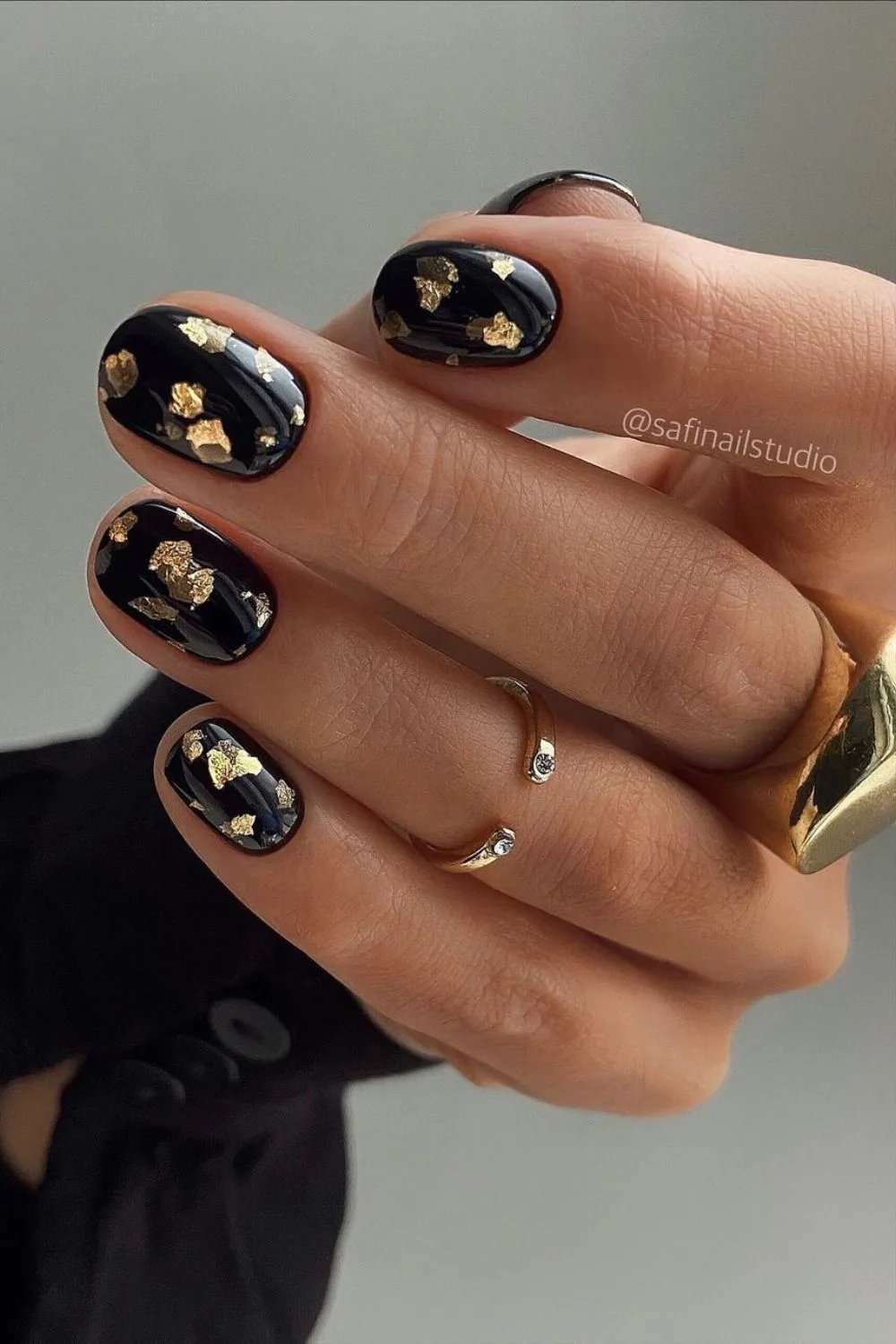 Black nails with gold foil accents