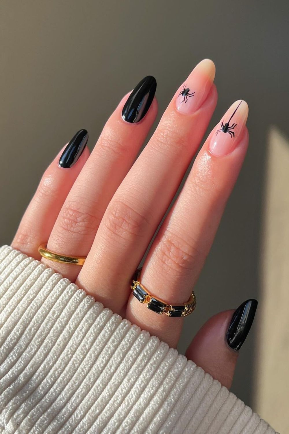 Black nails with nude and spider accent nails