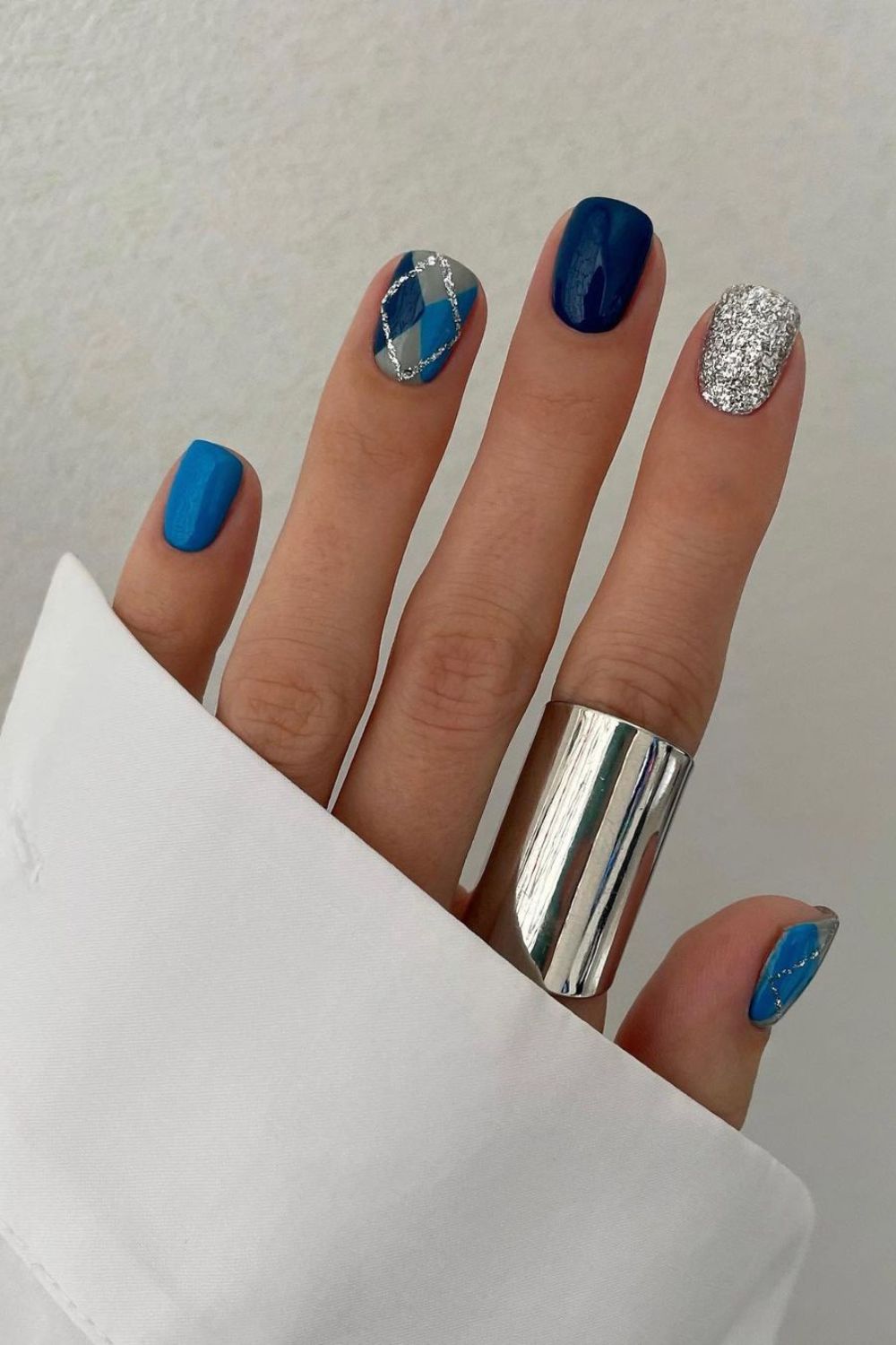 Blue nails with argyle and silver glitter accent