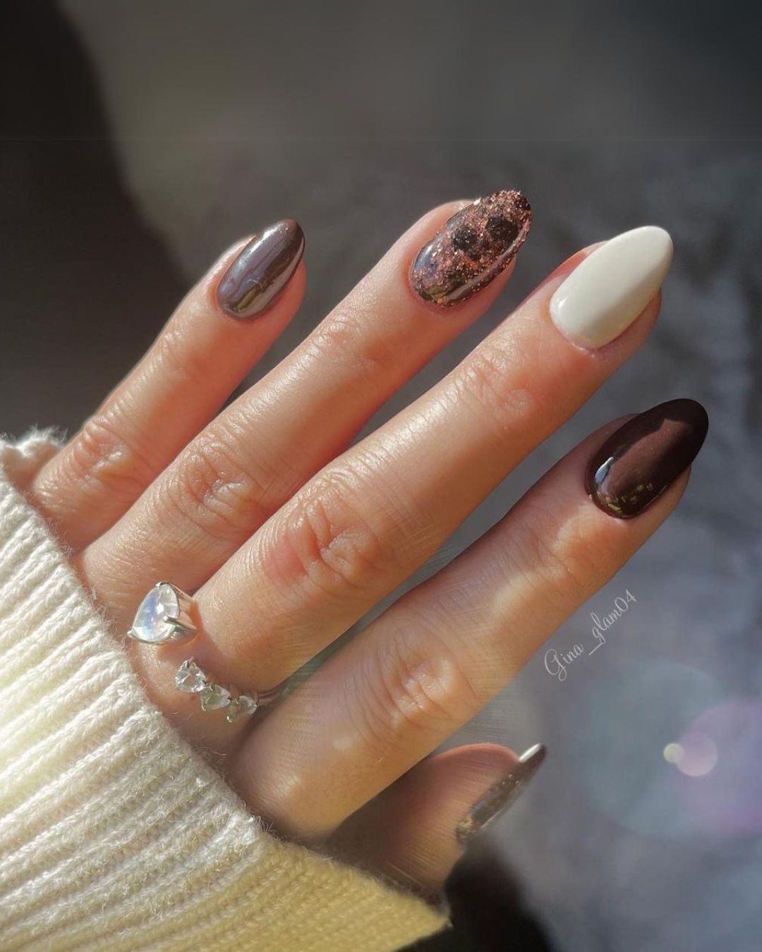 Brown and white nails with glitter accents