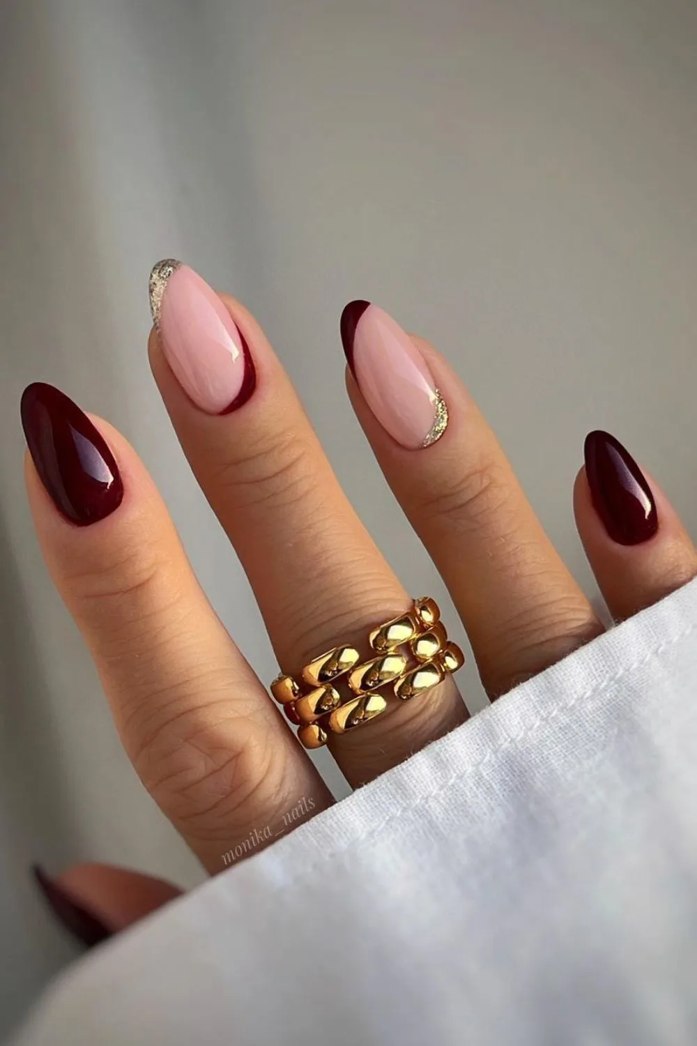 Burgundy and gold inverted french tip nails