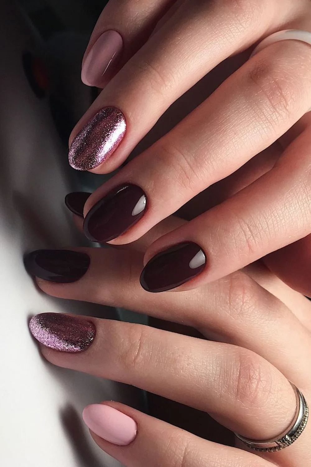 Burgundy and rose gold nails with glitter accent