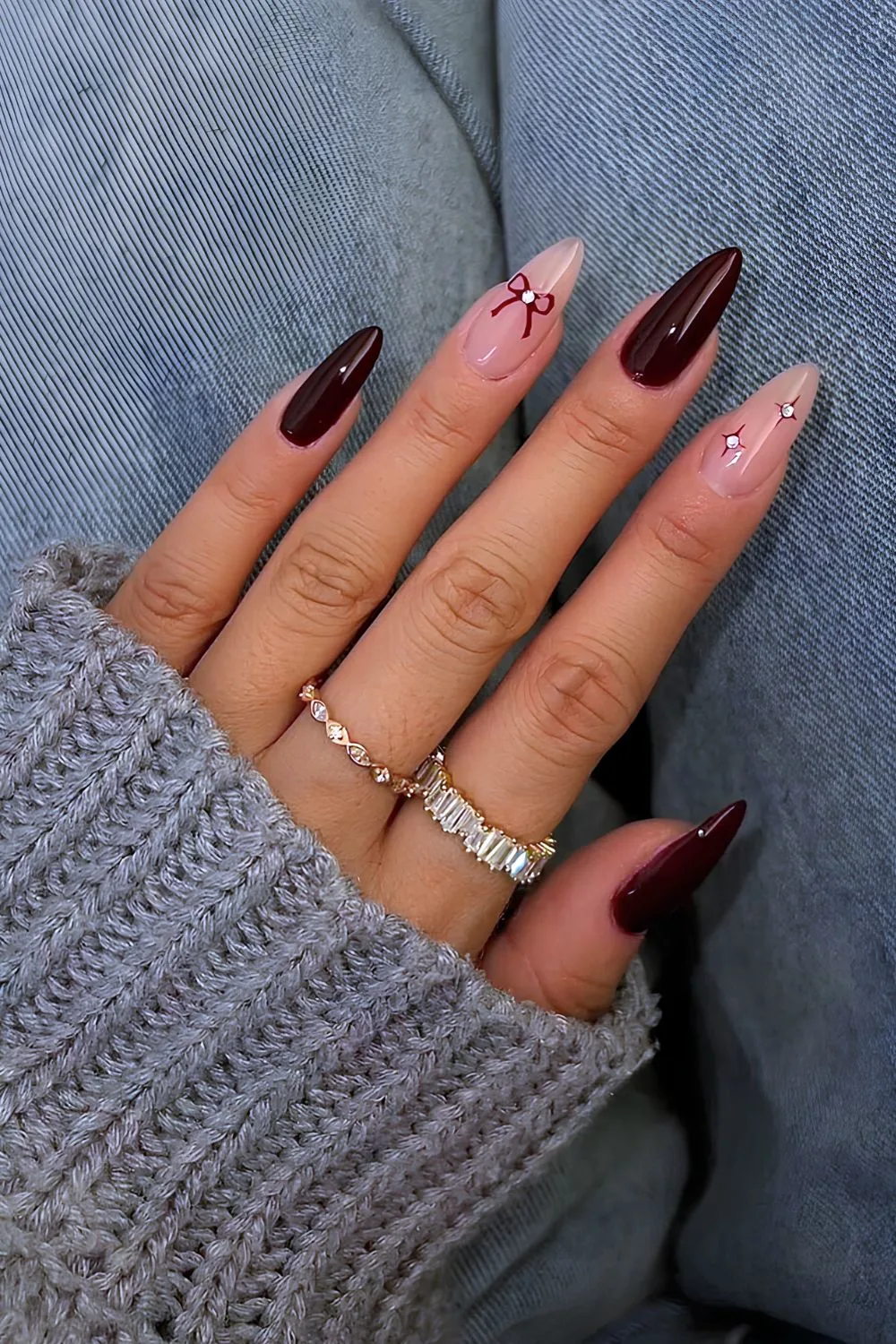 Burgundy coquette nails with bows and studs