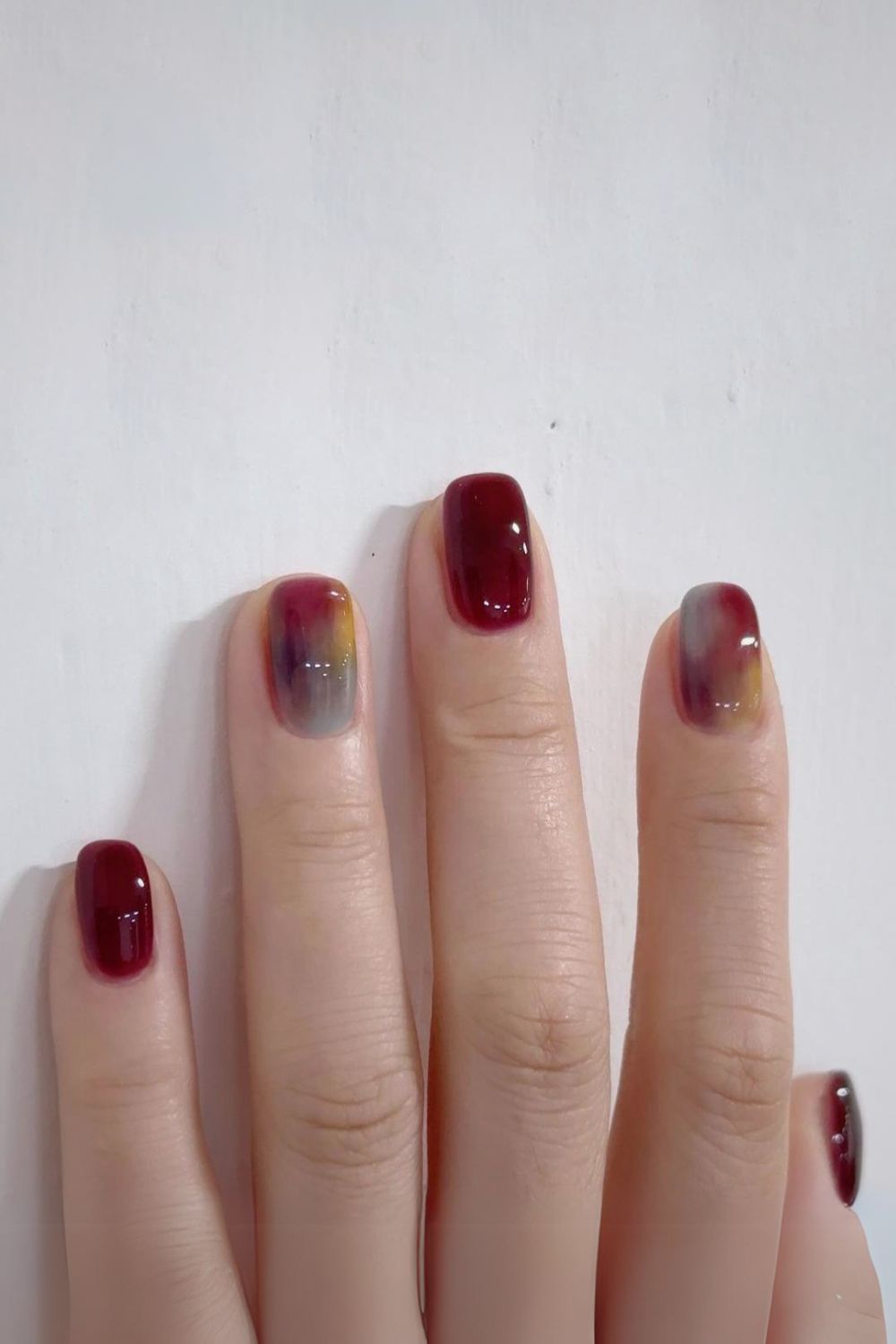 Burgundy mani with marble accents