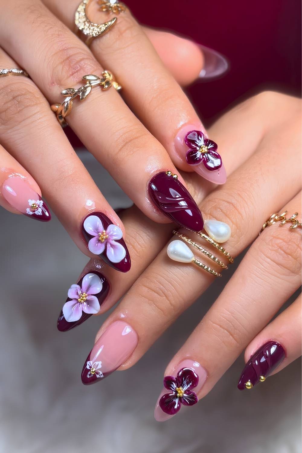 Burgundy manicure with sculpted flowers