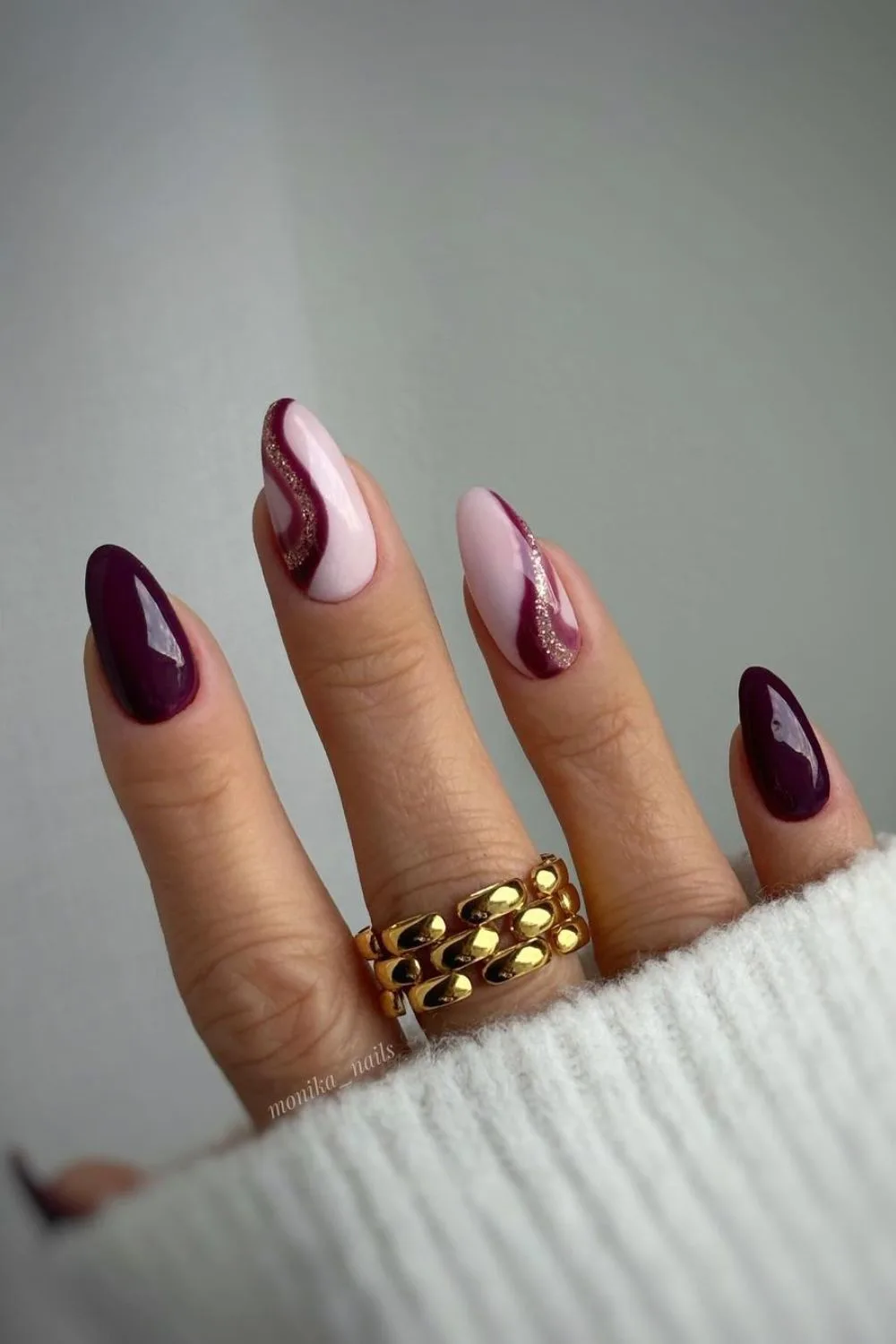 Burgundy nails with glittery swirls