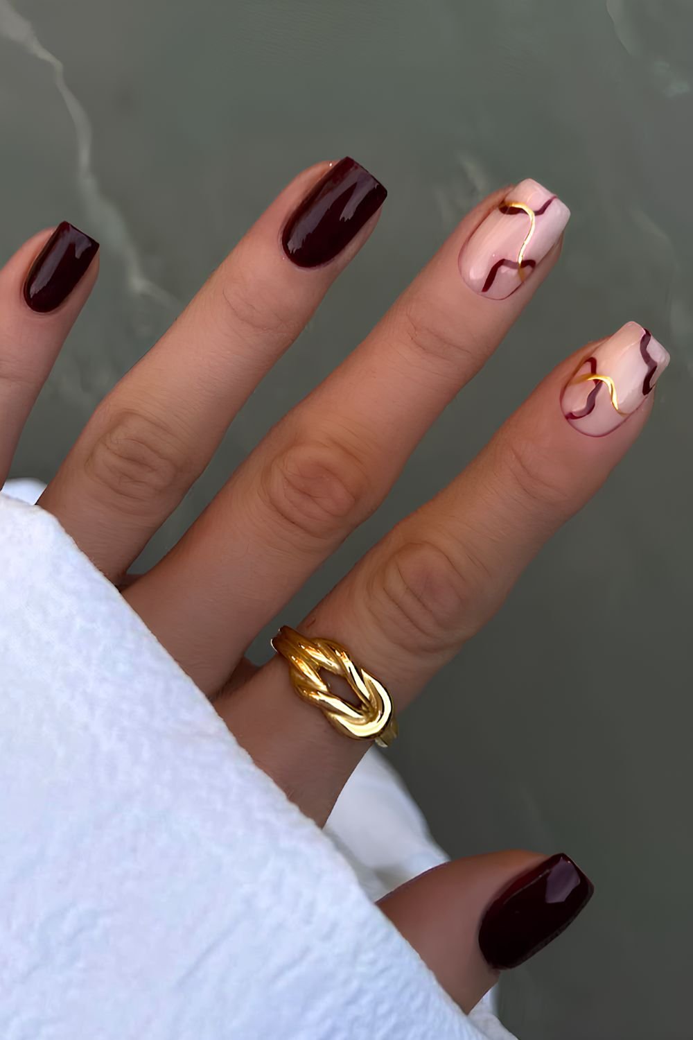 Burgundy nails with gold line art