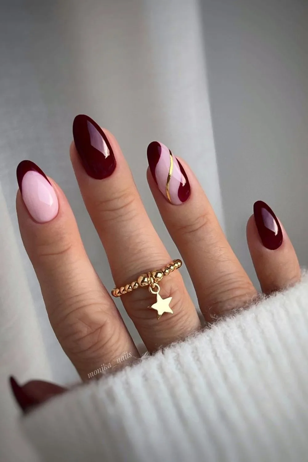 Burgundy nails with gold swirl accent