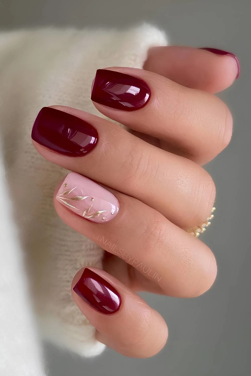 Burgundy nails with metallic leaf art