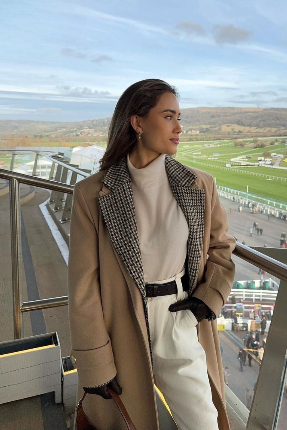 Camel coat with houndstooth lapels over turtleneck and white pants