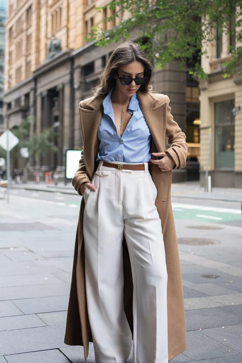 Camel coat with striped shirt and high-waisted trousers