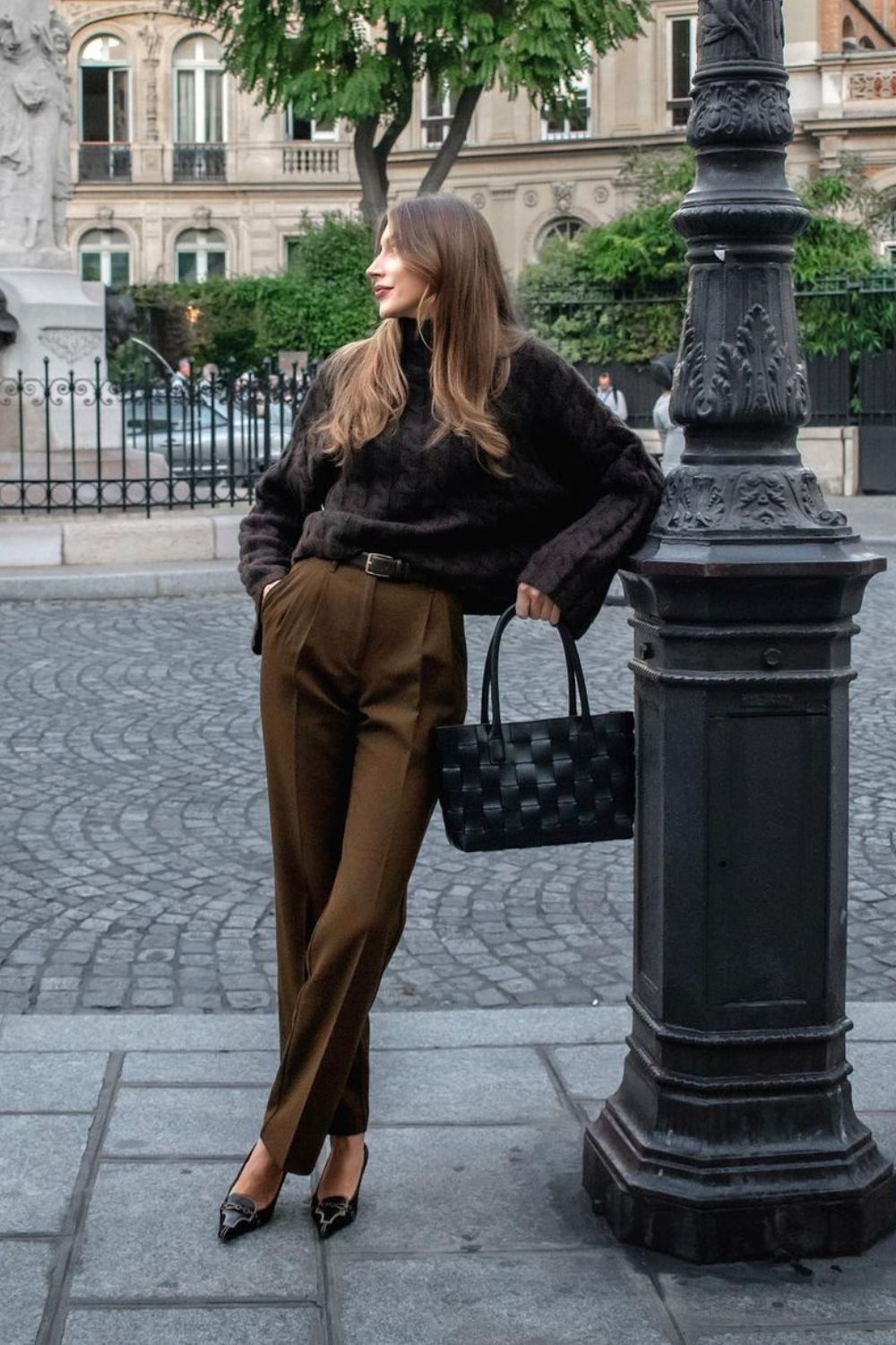 Chunky knit sweater with high-waisted brown trousers