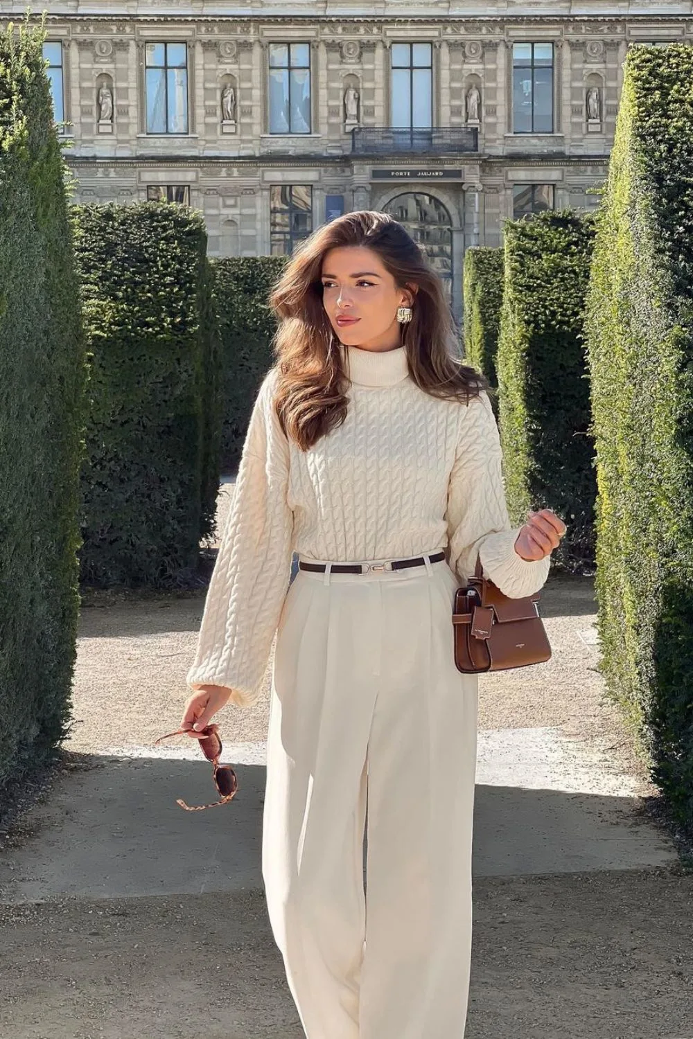 Cream cable-knit sweater with high-waisted trousers