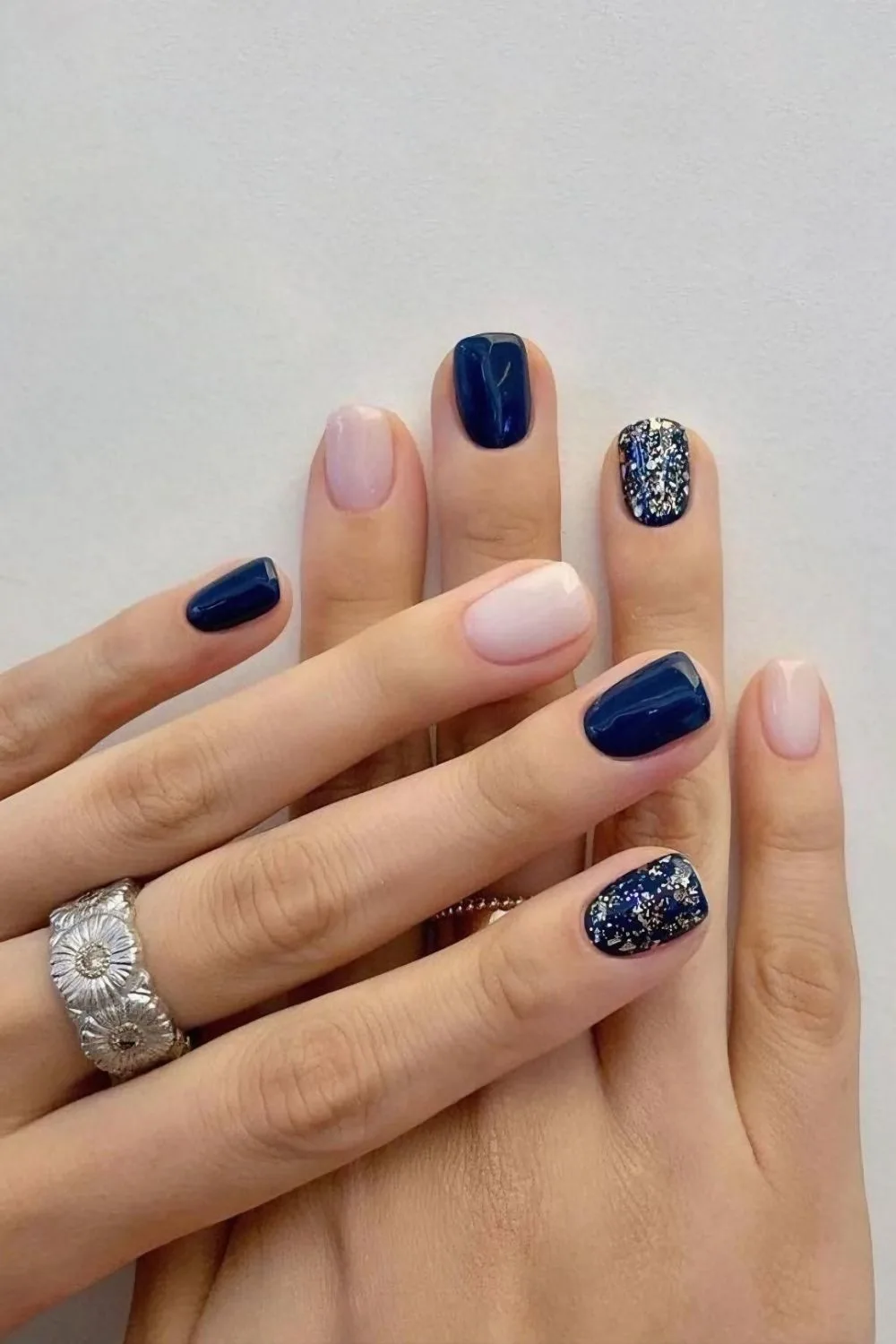 Dark blue mani with soft pink and glitter accent