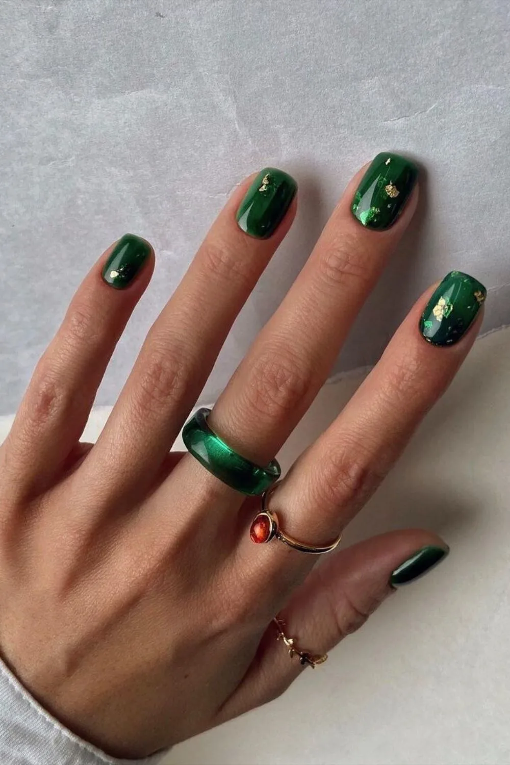 Dark green fall nails with gold foil accents