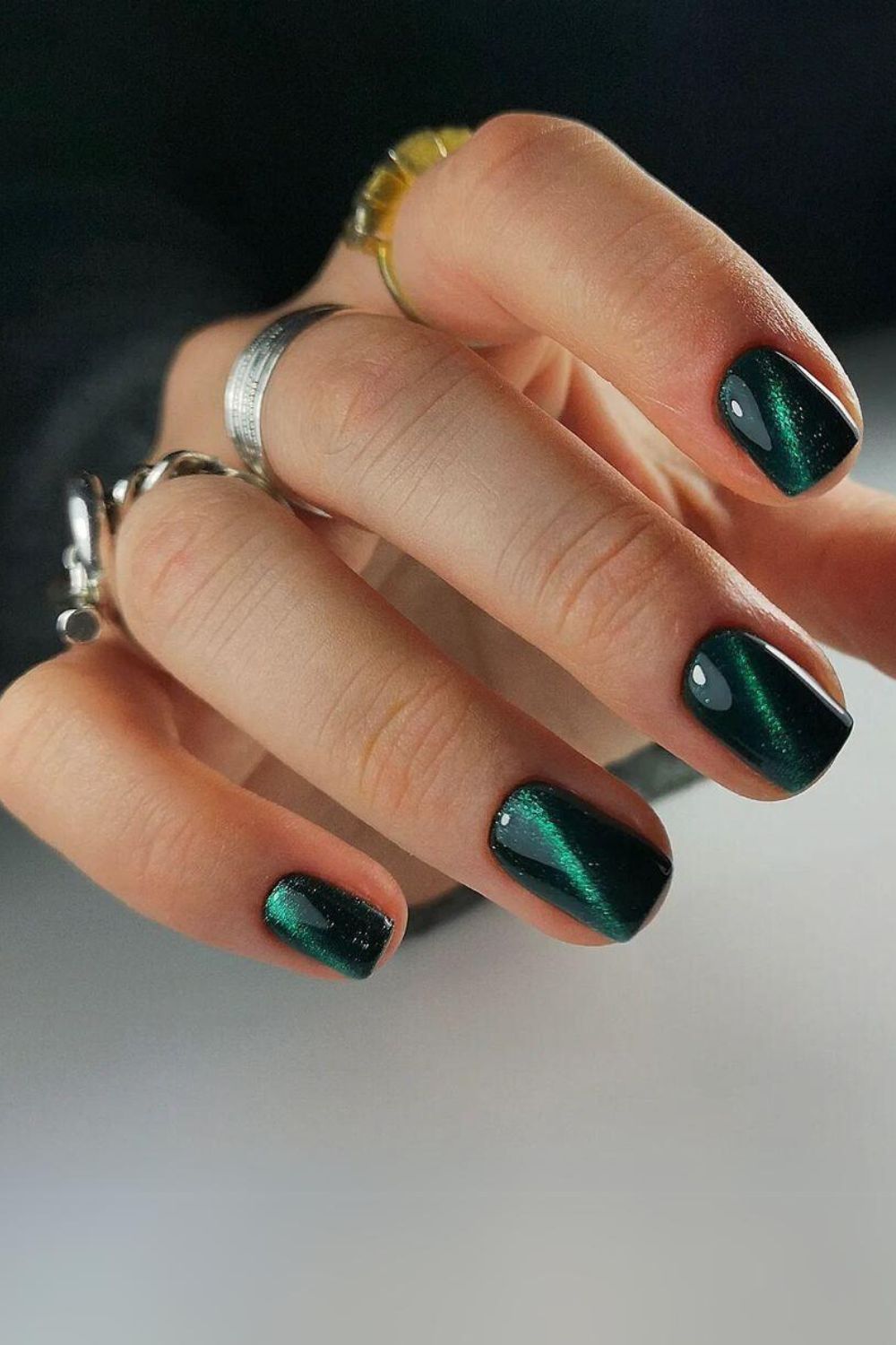 Dark green nails with cat eye effect