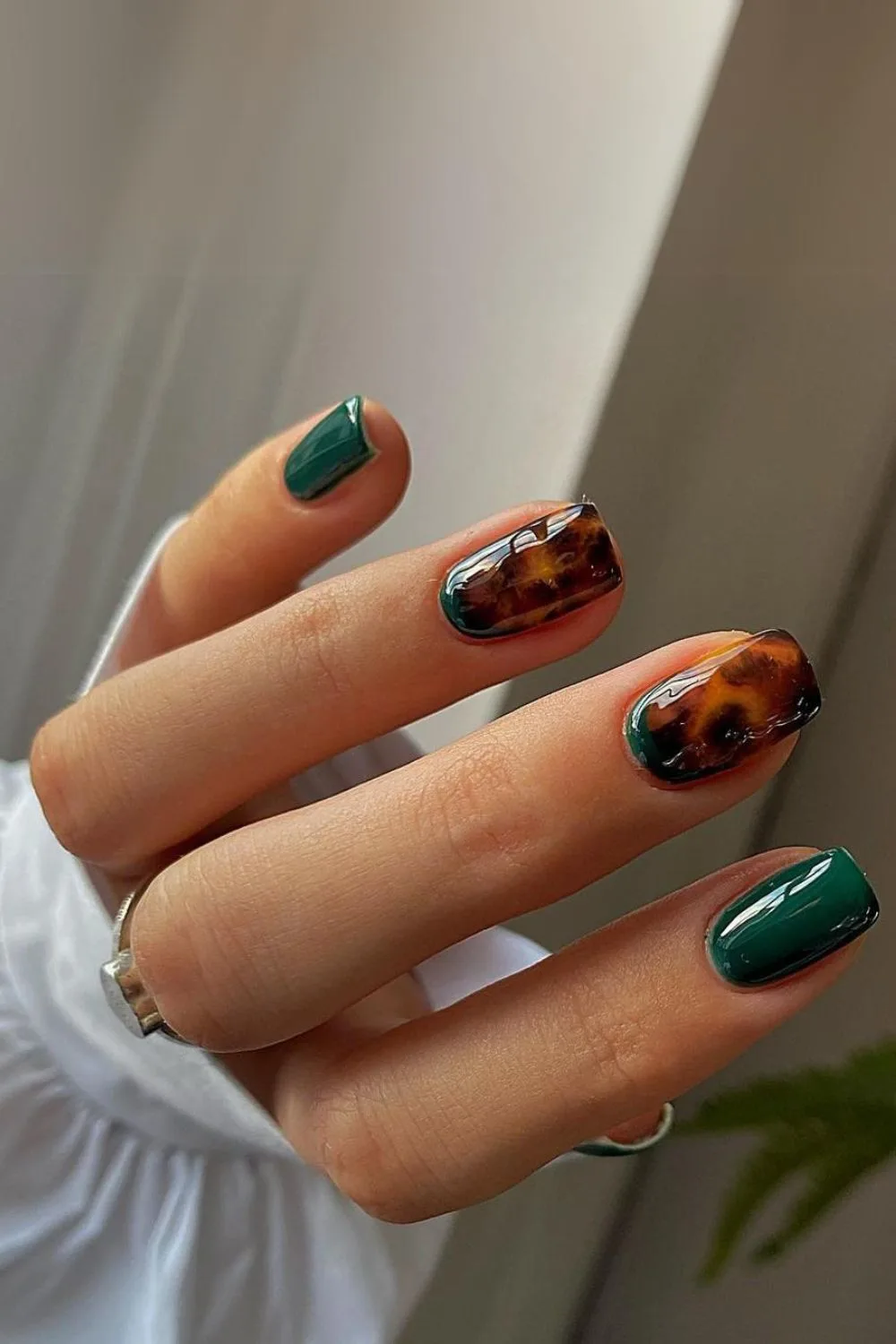 Dark green nails with tortoise shell accent