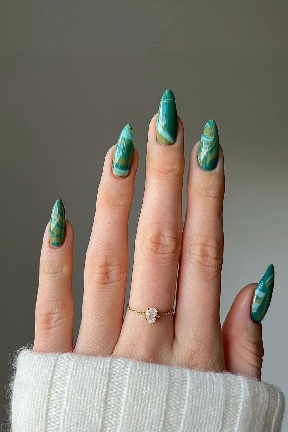 Dark green water marble effect nails