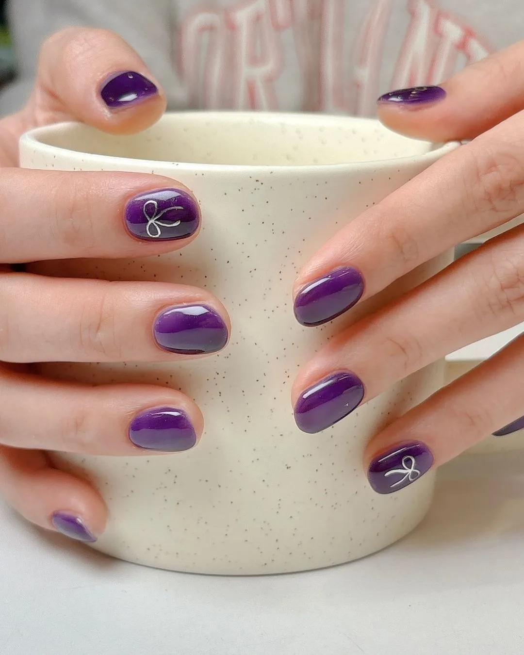 Dark purple nails with bows