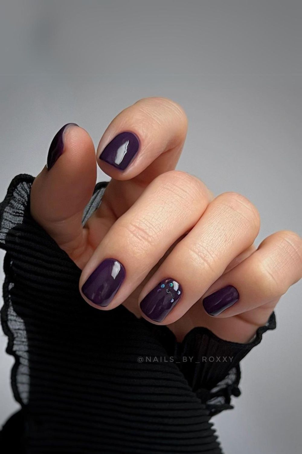 Dark purple nails with subtle glitter