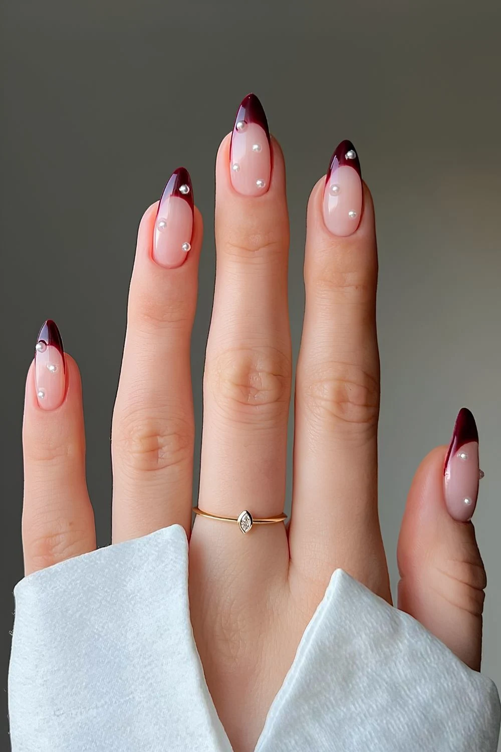 Dark red French manicure with pearls