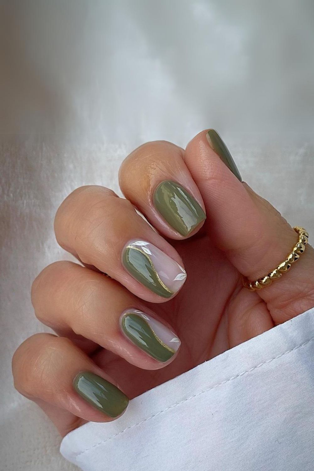 Elegant olive green nails with gold accents