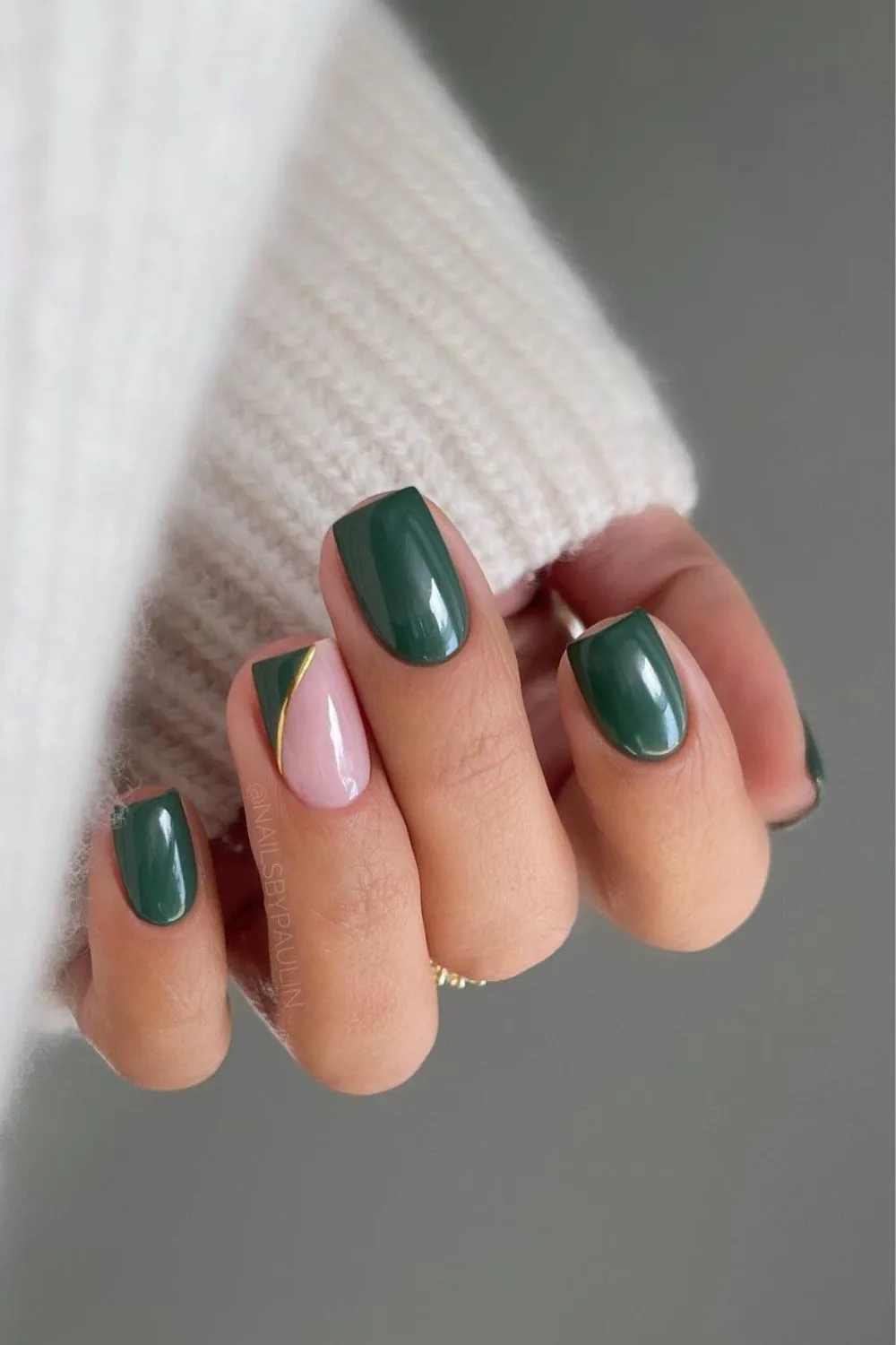 Emerald green nail with subtle gold accent