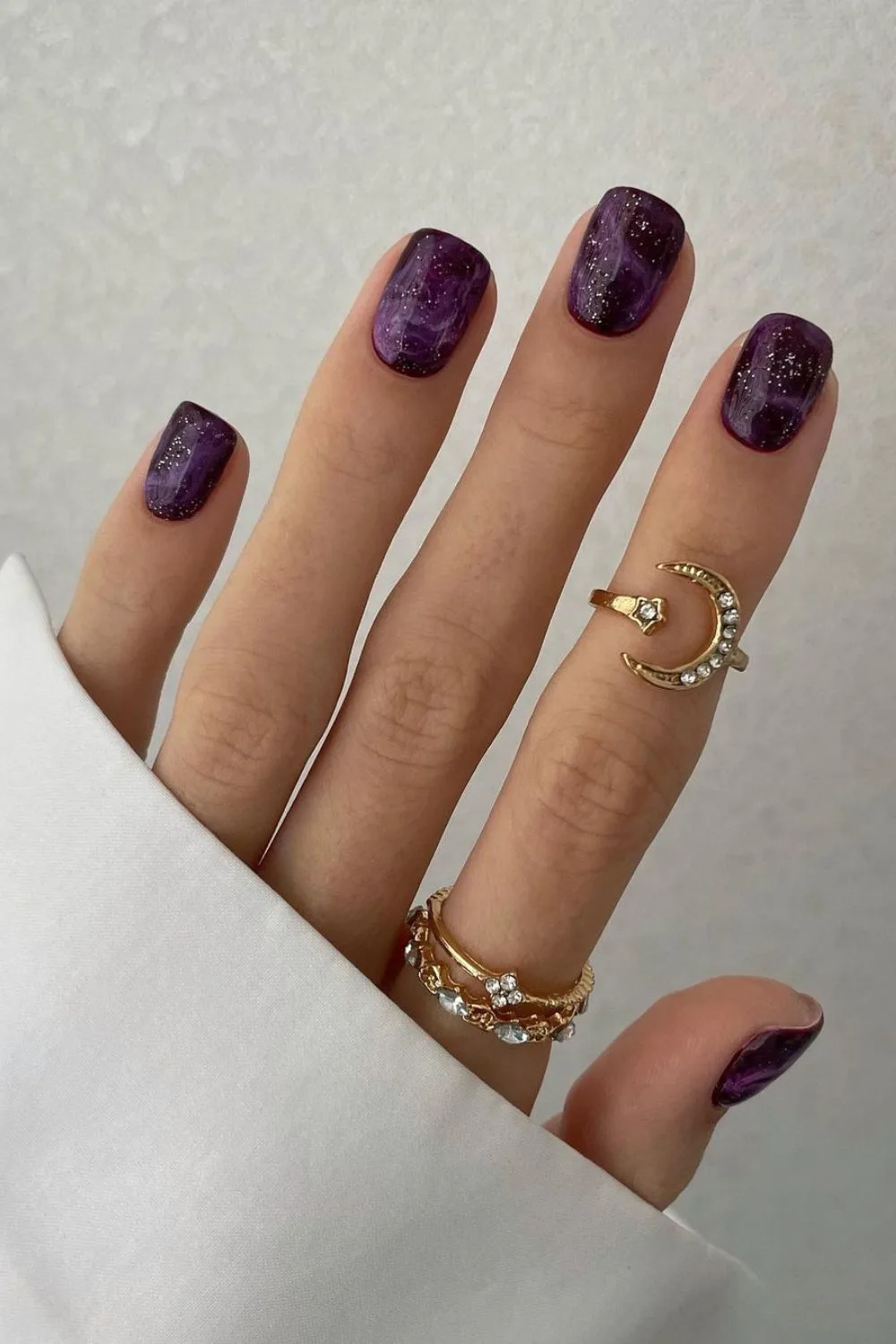 Glittery dark purple marble nails