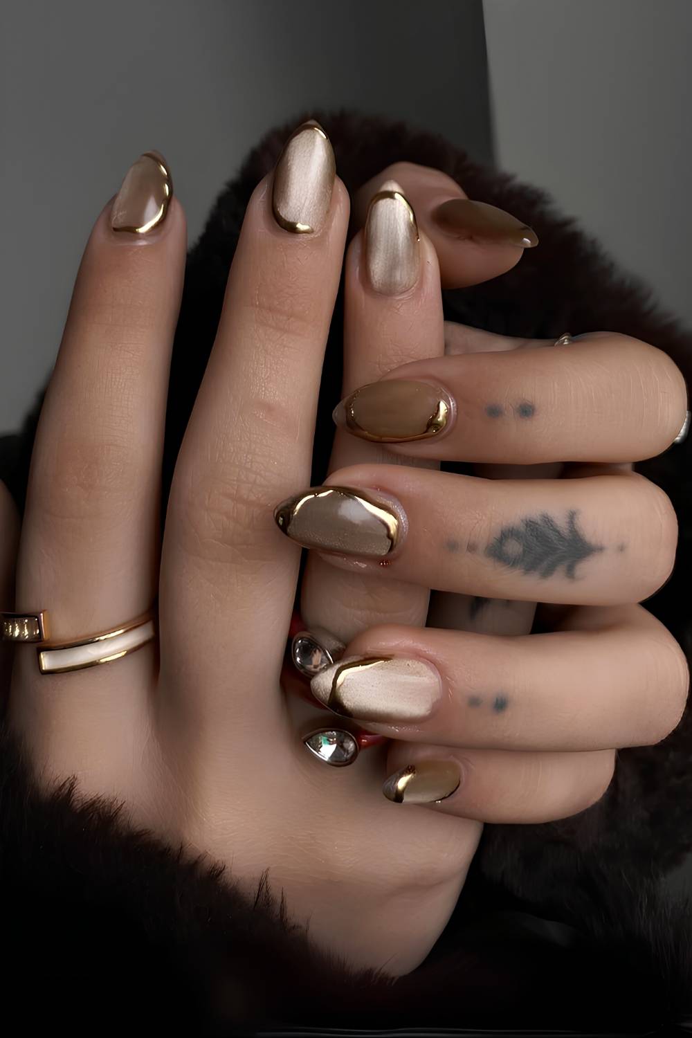 Gold cat eye nails with metallic accents