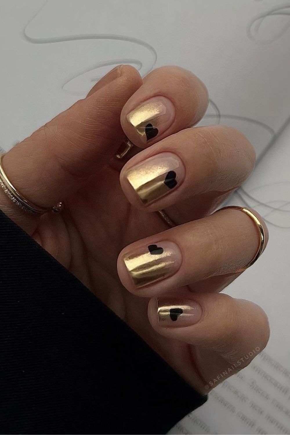 Gold nails with black hearts