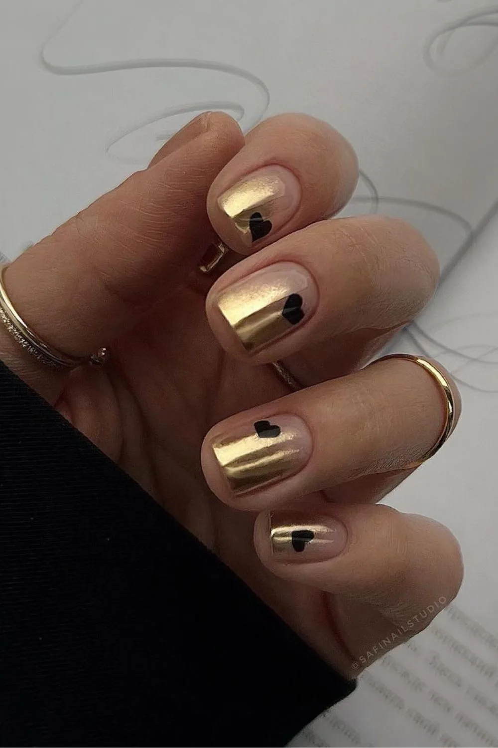 Gold nails with black hearts