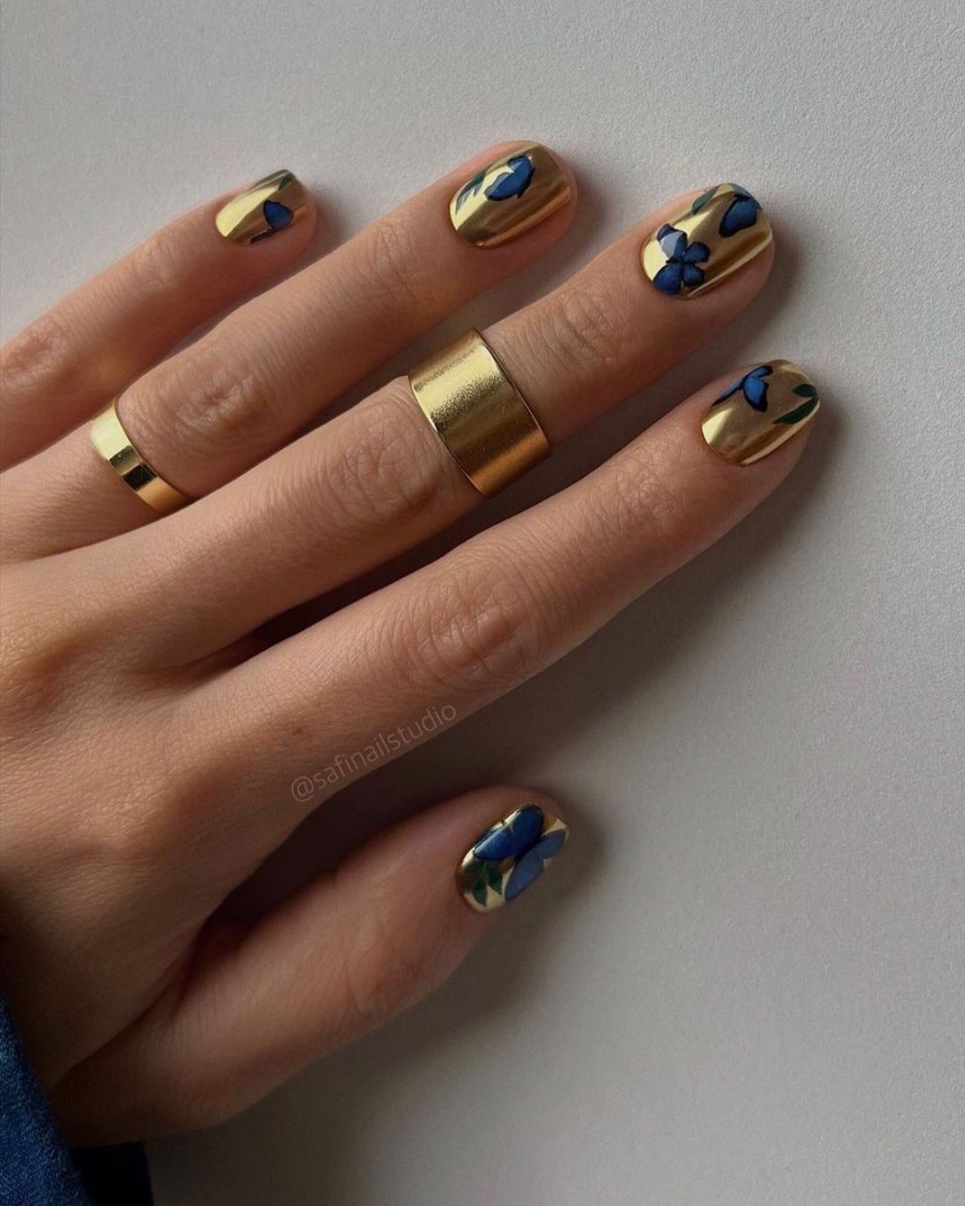 Gold nails with blue butterflies